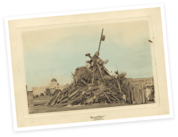 1928’s Aggie Bonfire on the drill field in front of the
								Academic Building was still the old “trash pile” style of
								bonfire.